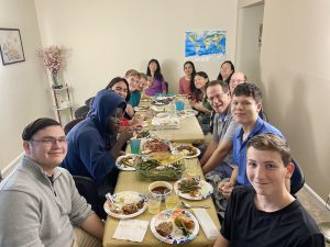 A group of people of all ages eating at a table.